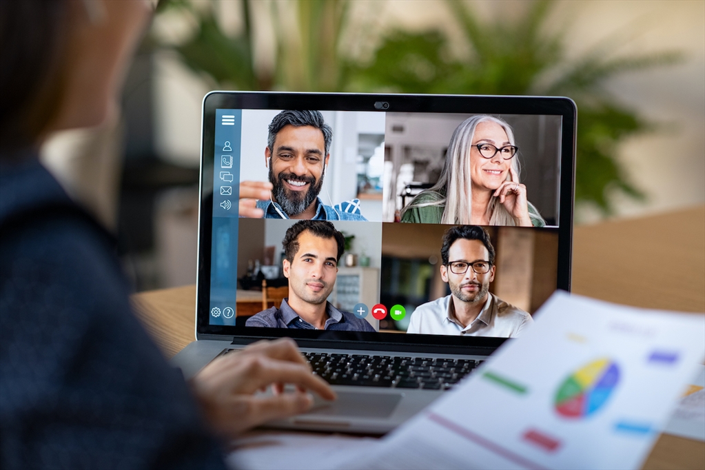 Picture of a person doing a video conference call with 4 other people