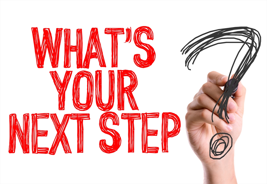 Picture of a hand drawing a question mark with the text "WHAT'S YOUR NEXT STEP?" to the left