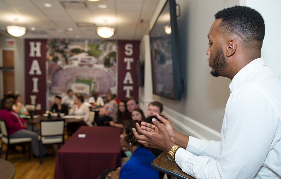 Picture of an MSU Representative speaking to students at an event